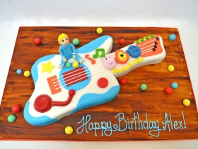 BABY WITH TOY GUITAR CAKE