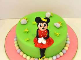 MINIE MOUSE SITTING ON CAKE